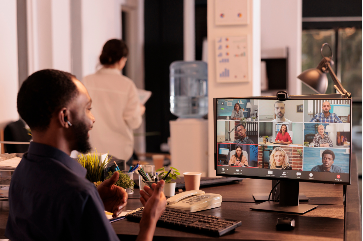 Business video conferencing. Young man having video call via computer in the home office.