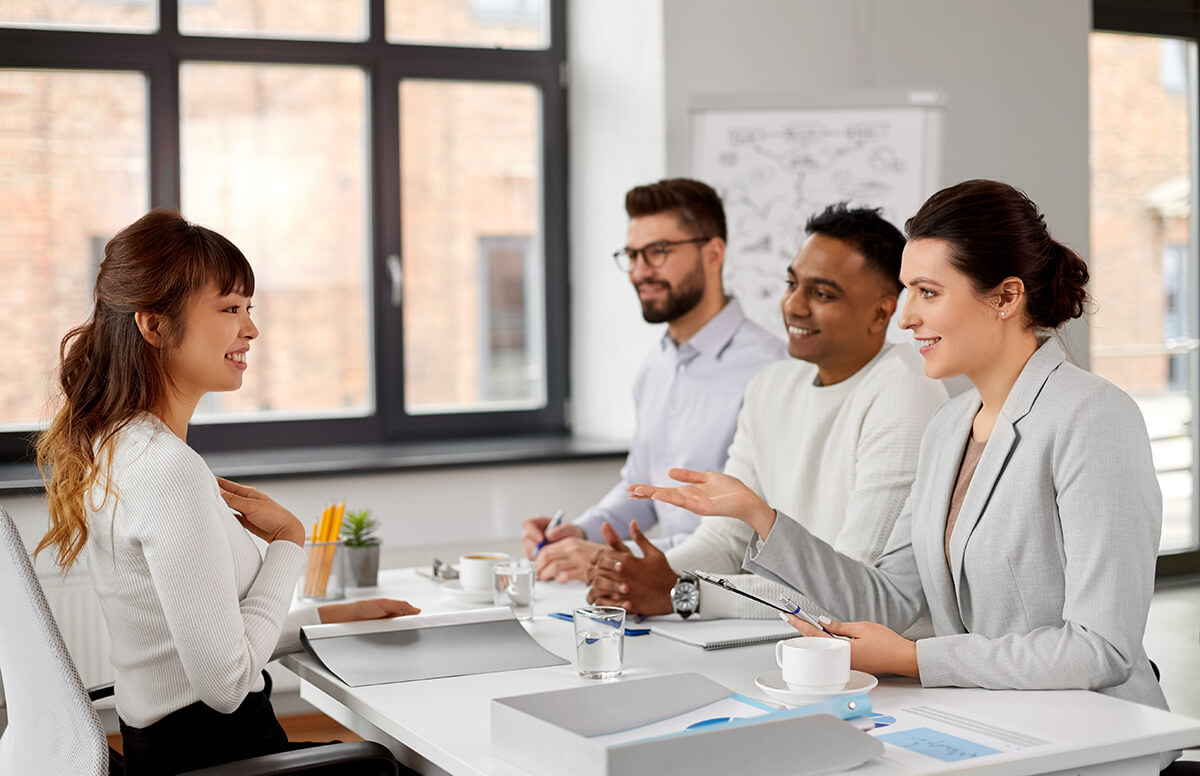 A group of people sitting at a desk