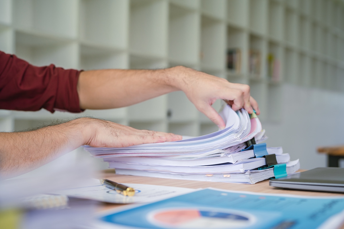 Office,Employee,Working,With,Documents,At,Table,,Closeup
